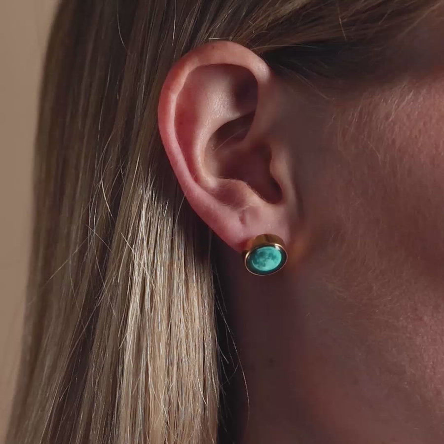 Video of woman wearing Moonshine Stud Earrings in Gold with glow in the dark