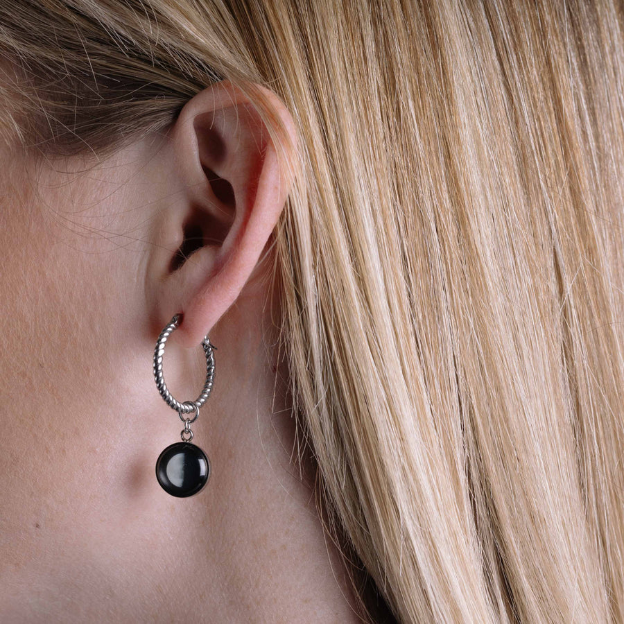 Woman wearing The Carina Hoops in Stainless Steel