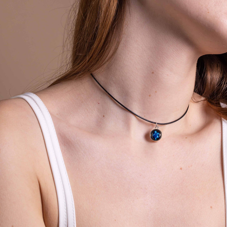 Woman wearing silver plated constellation astrology pendant with leather choker