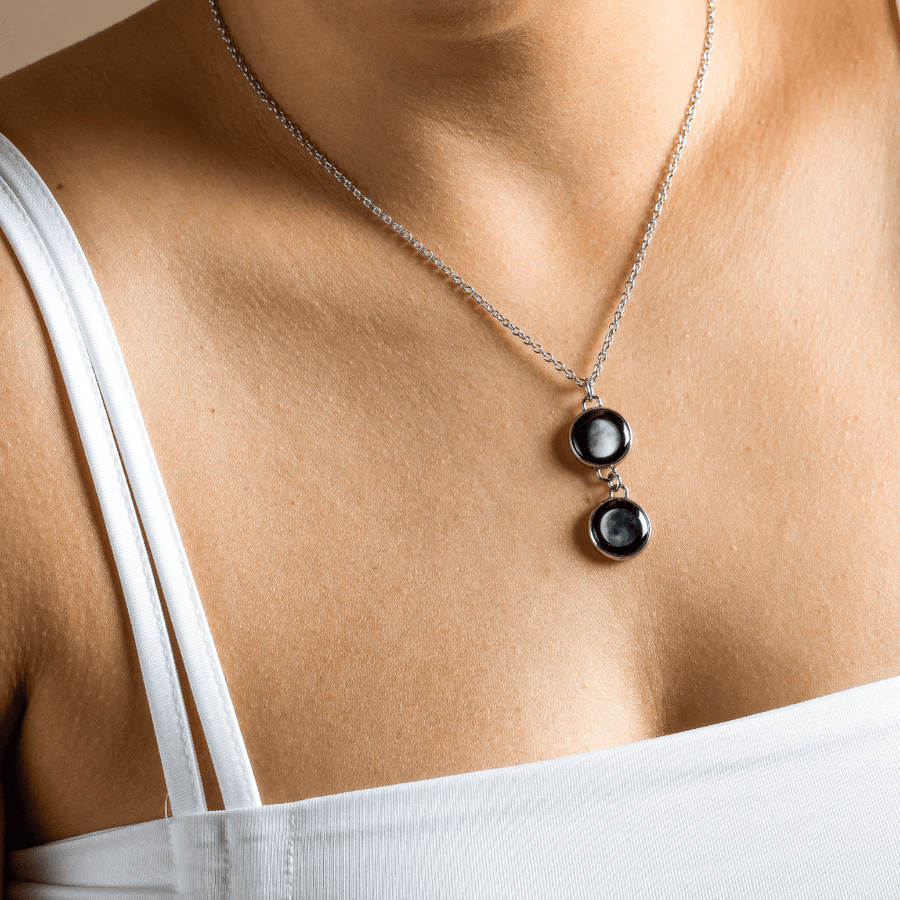 Woman wearing 2 moon phase necklace in stainless steel