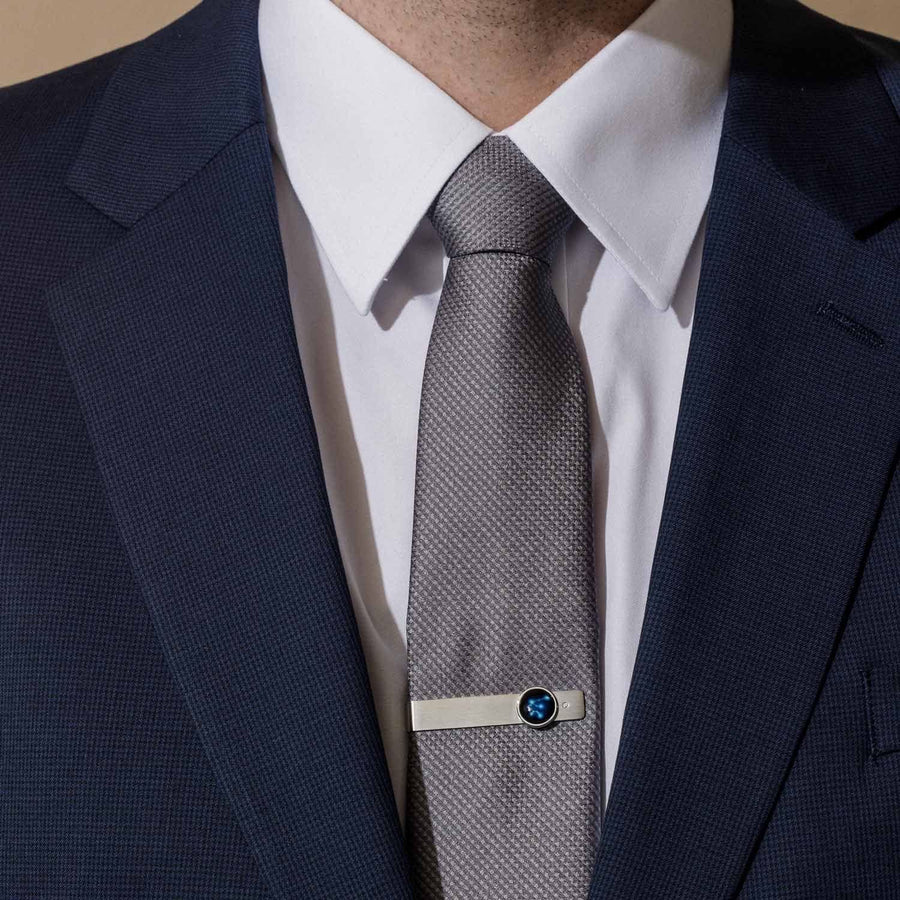 Man in a suit wearing a Constellation Astrology Tie Bar In Stainless Steel