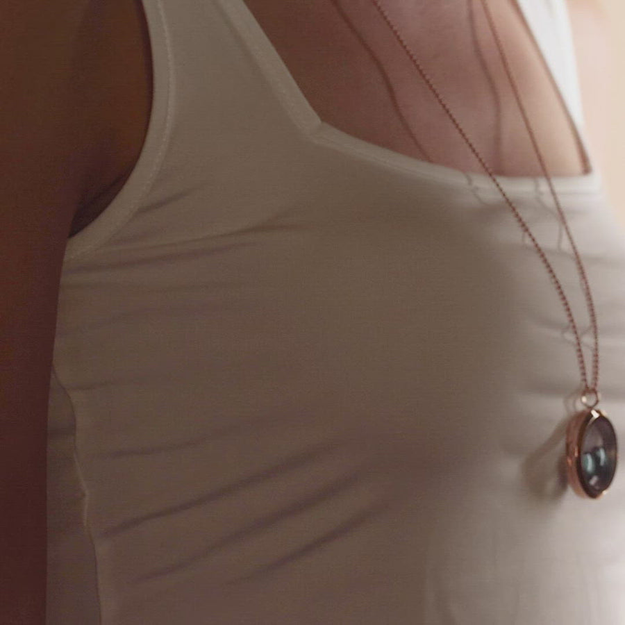 Video of woman wearing two moon phase locket necklace in stainless steel