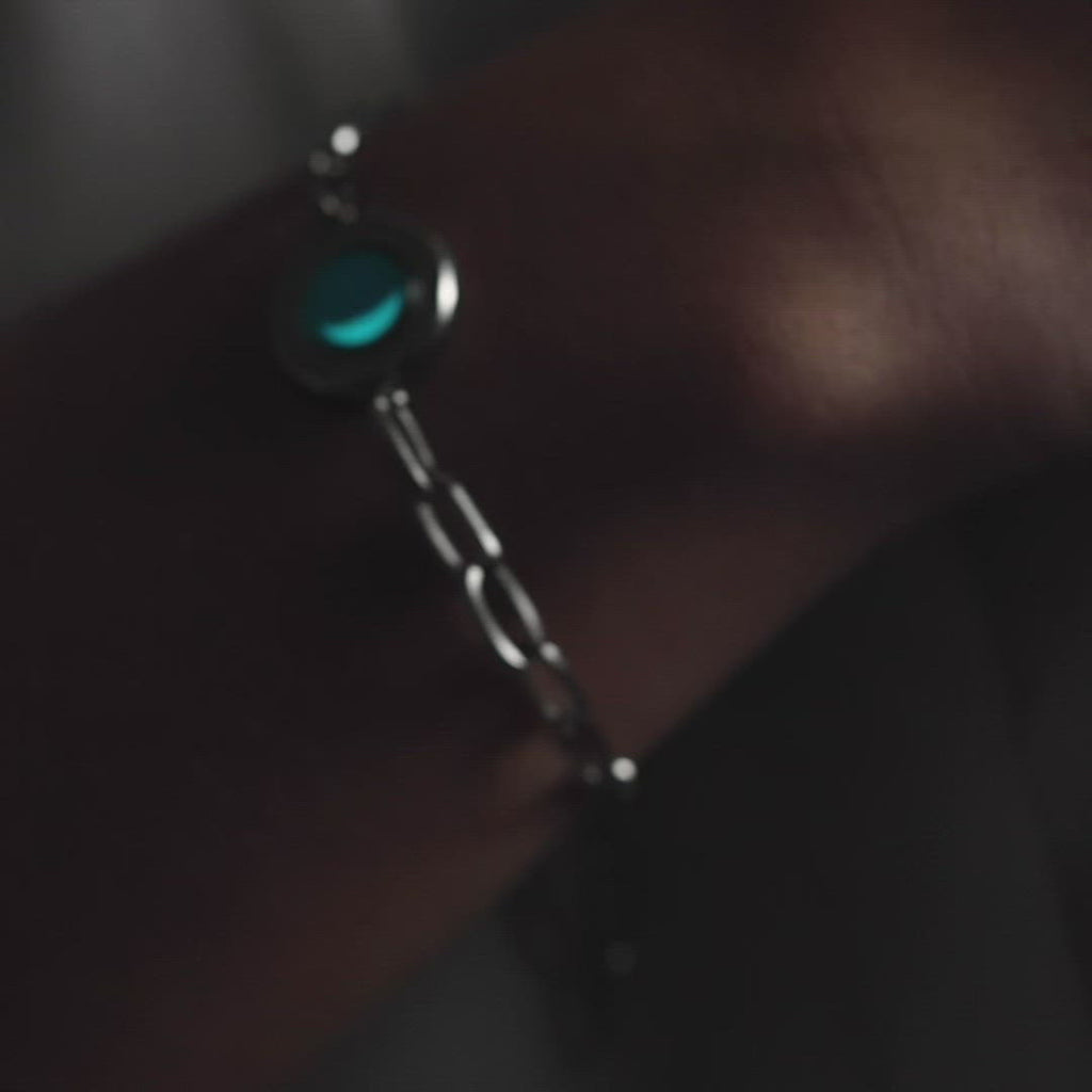Video of woman wearing The Asterism Link Bracelet in Stainless Steel in the dark. Glow in the dark.