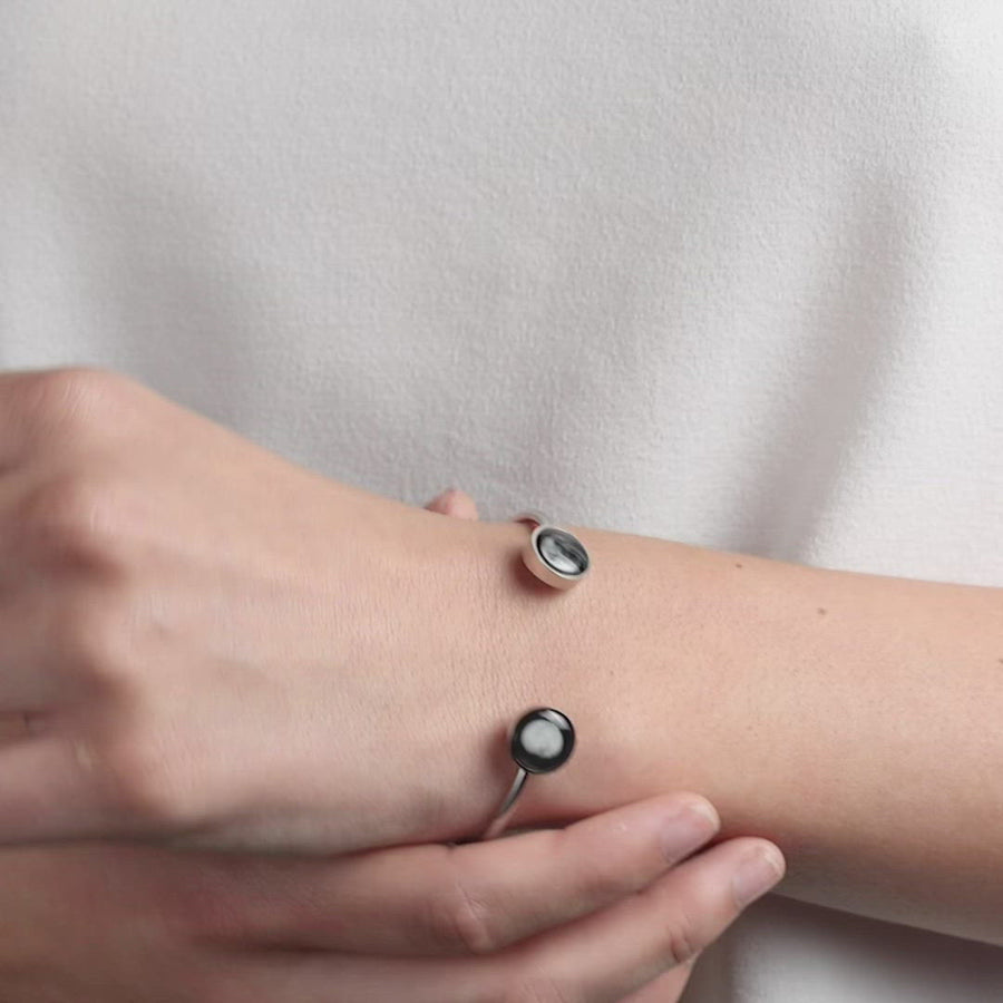 Video of woman wearing 2 moon phase cuff bracelet in stainless steel