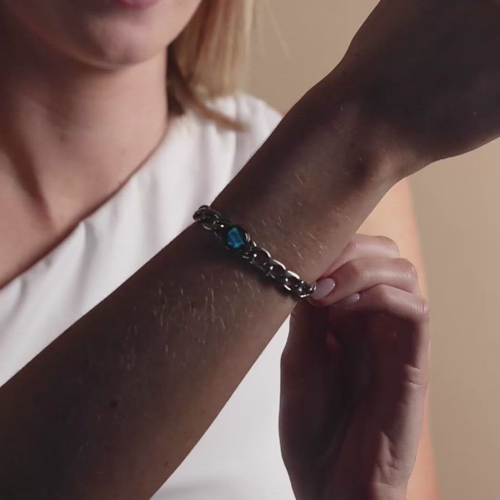 Video of woman wearing glow in the dark stainless steel constellation astrology link bracelet