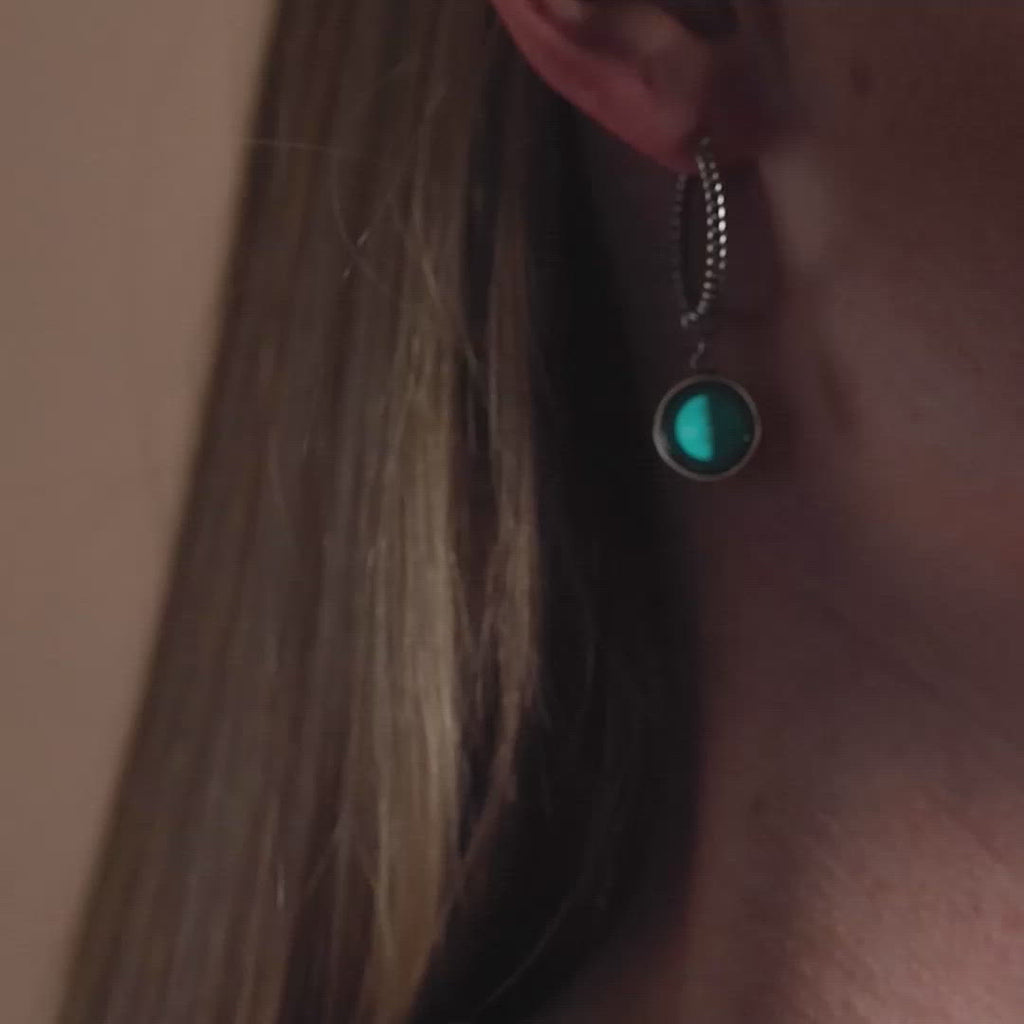 Video of woman wearing The Carina Hoops in Stainless Steel in the dark. Glow in the dark.